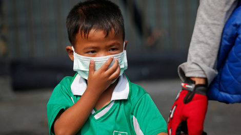 This little cutie’s covering his face to protect himself from air pollution. :(